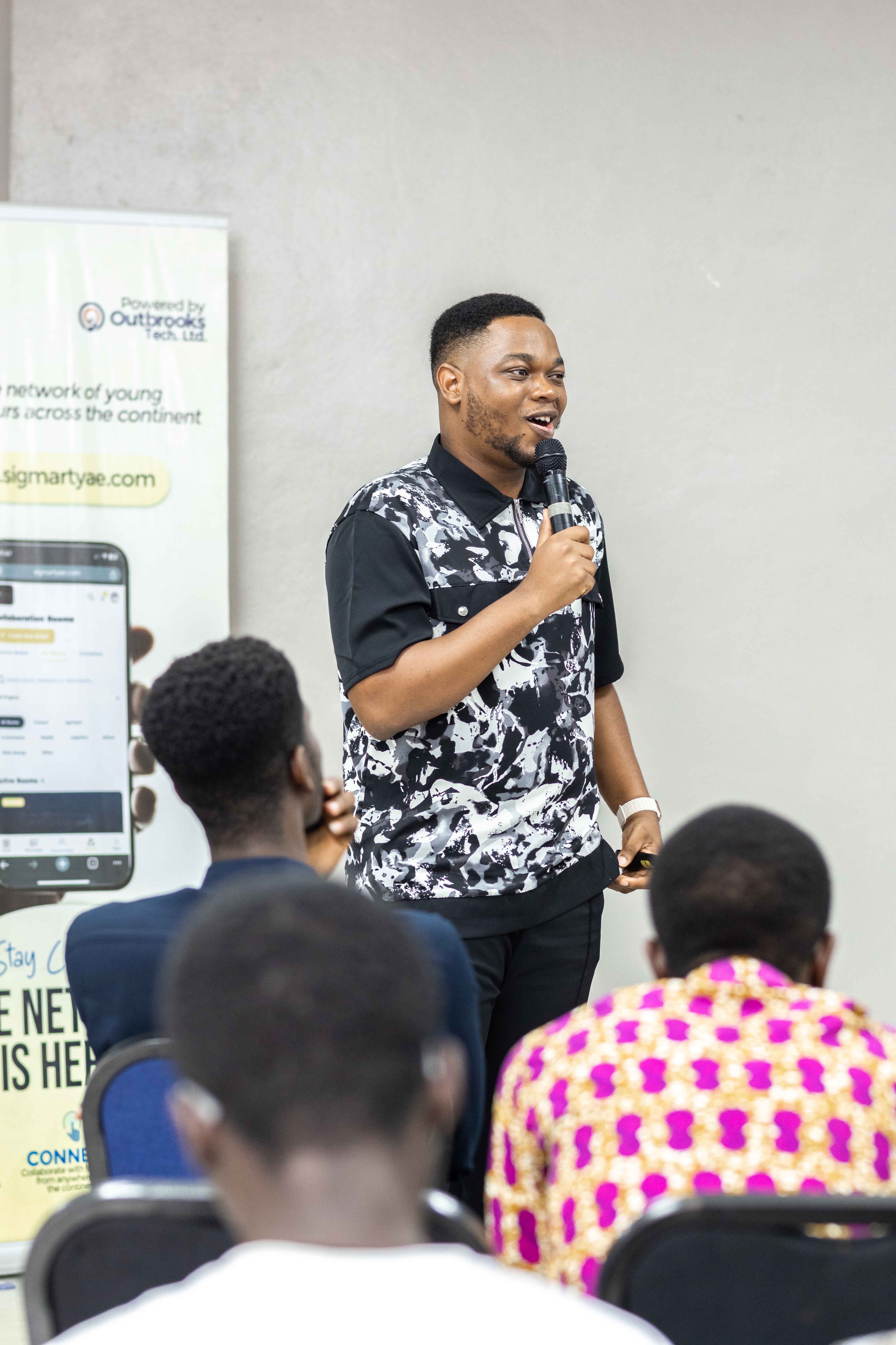 Samuel Adanuvo presenting at a Sigmart YAE event
